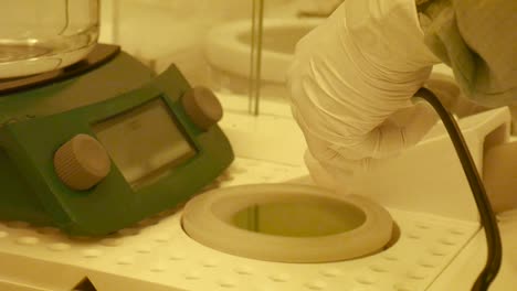 the hands of a scientist cleaning a microchip in the clean lab or clean room