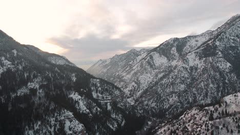 wasatch mountains at sunset in american fork canyon, utah - aerial in winter