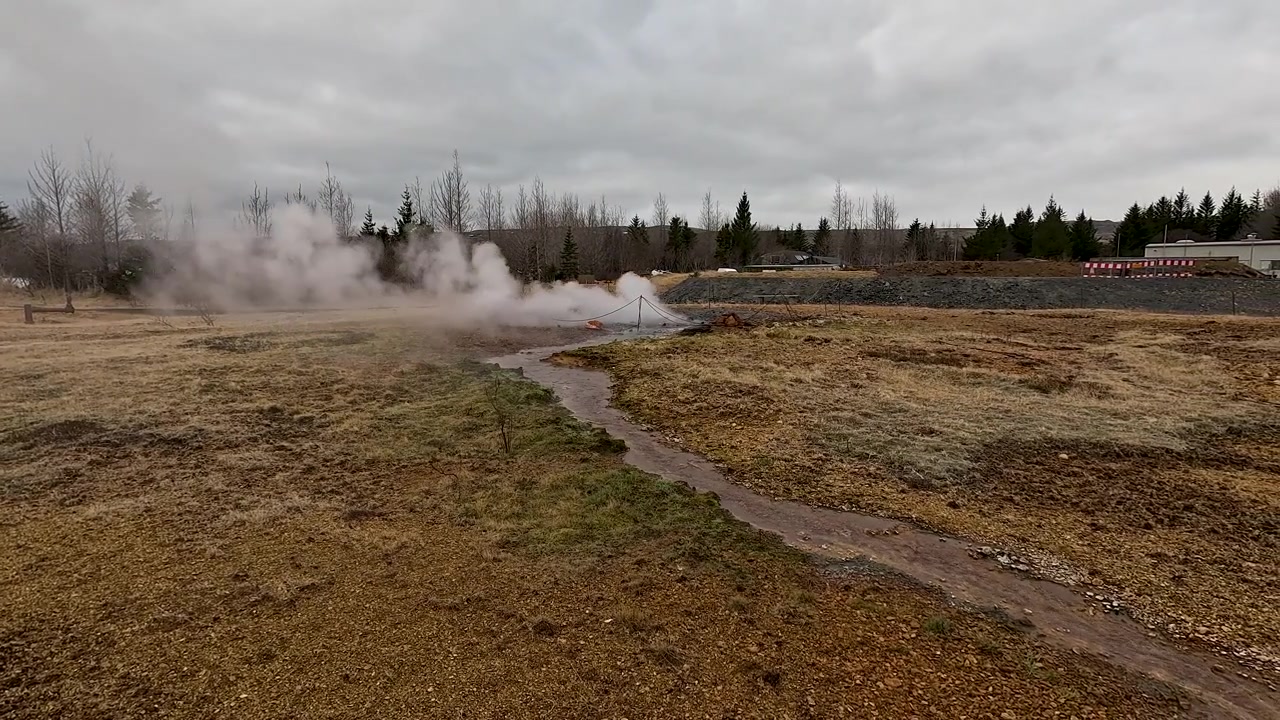 Authentic footage of geothermal steam rising from a natural vent in the Icelandic countryside, showcasing renewable energy and volcanic activity.