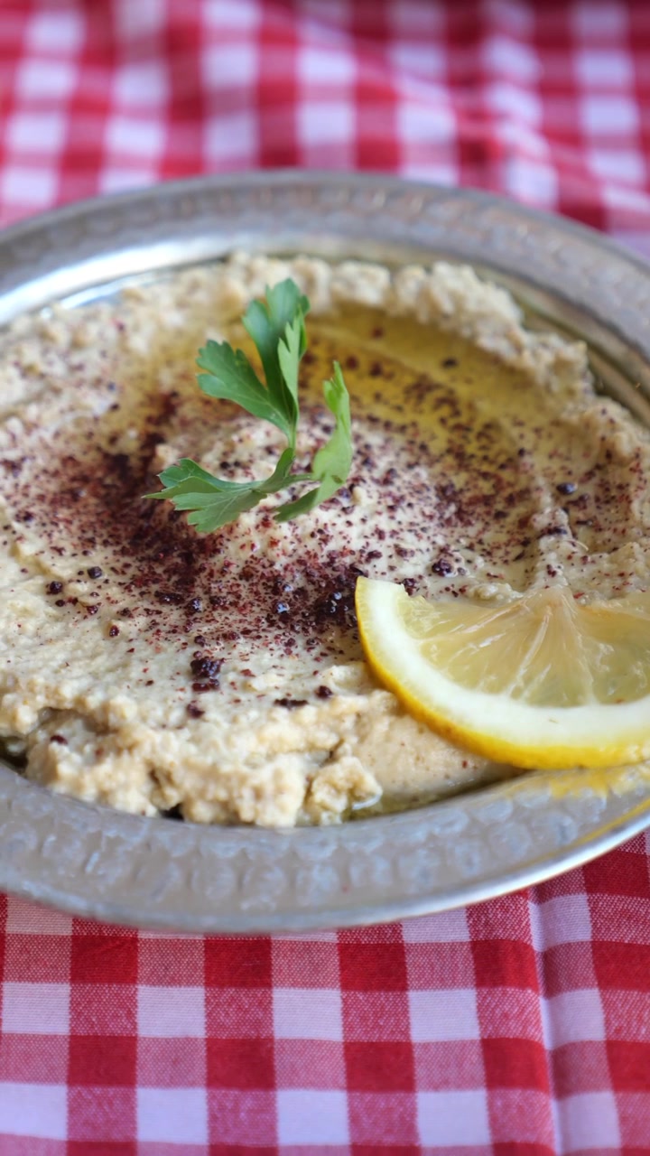 Hummus tradizionale guarnito con limone e prezzemolo