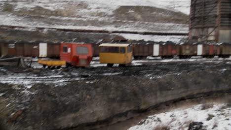 Tilt-down-to-polluted-channel-at-abandoned-mining-camp-in-Argentina