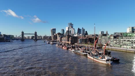old sailing barges moored on river thames tower bridge london uk in background