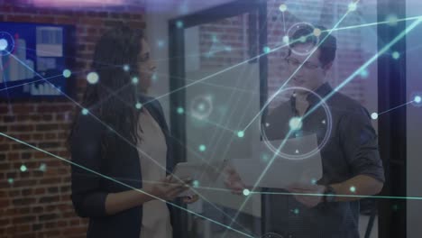 animation of communication network over male and female colleague talking in office