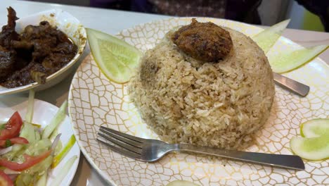 traditional bengali food, basmati kacchi biryani and mutton kala bhuna at a restaurant in dhaka. it is very delicious food and also very famous in all over the world.