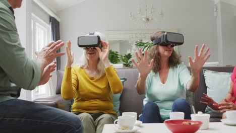 Animation-of-happy-diverse-female-and-male-senior-friends-using-vr-headset-and-having-fun