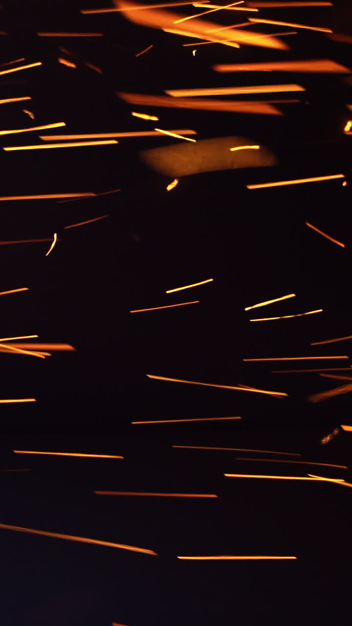 Grinding glitter manufacturing. Grinder sparks flying pattern. Vertical video