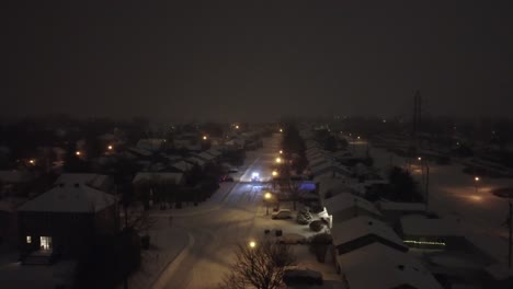 winter snow covered canada neighborhood suburban houses at night, drone aerial