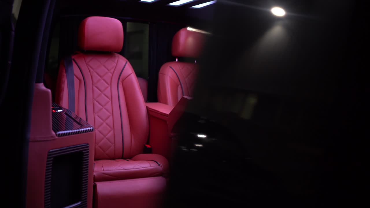 Nice interior shot of a luxurious limousine, van shuttle for business owners. Red seats with some nice LED lights on the roof. Perfect interior clip for transportation.