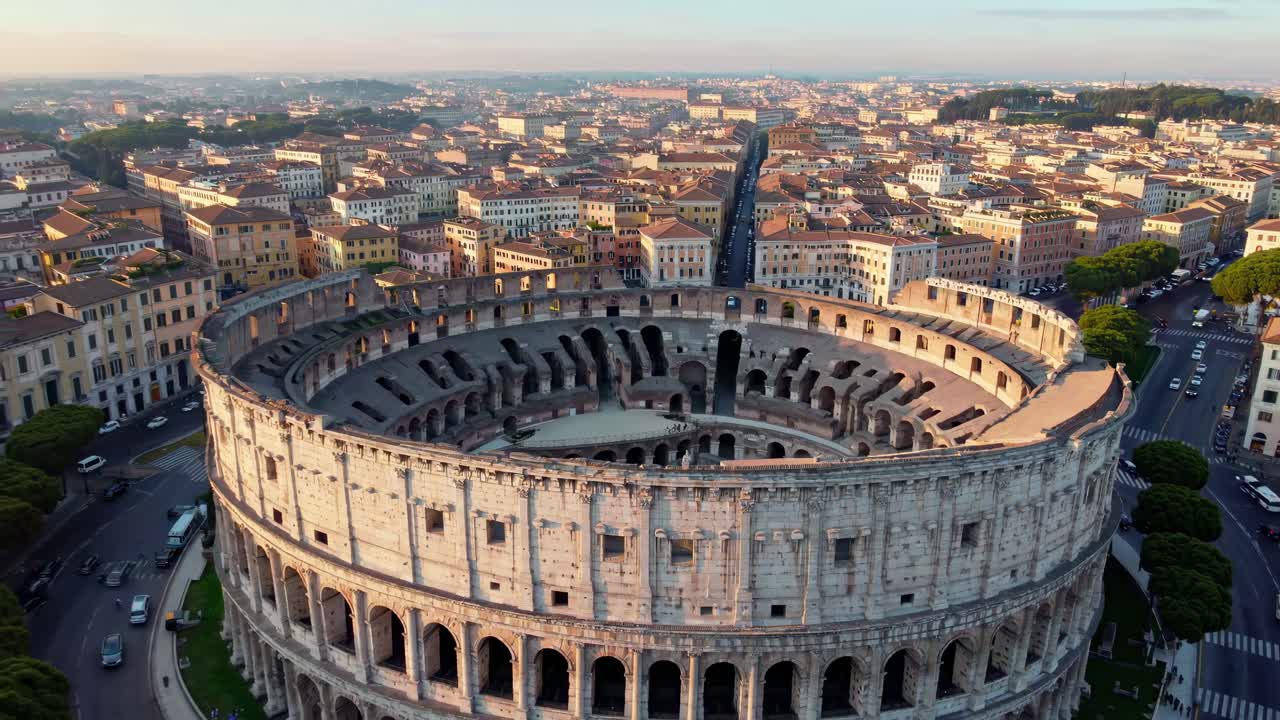 Aerial view video of the Colosseum at sunrise, showcasing its ancient architecture amidst the modern