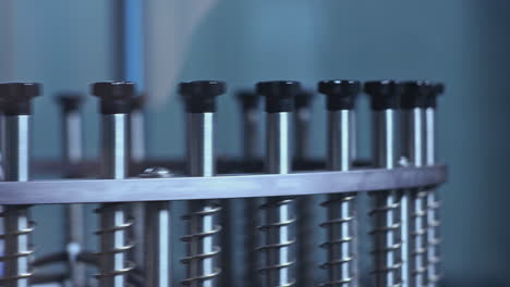 Industrial equipment. Circling metal sticks of machine. Part of production line