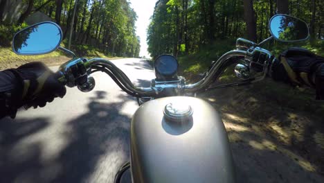 riding a motorcycle. biker rides on the road with a first-person.