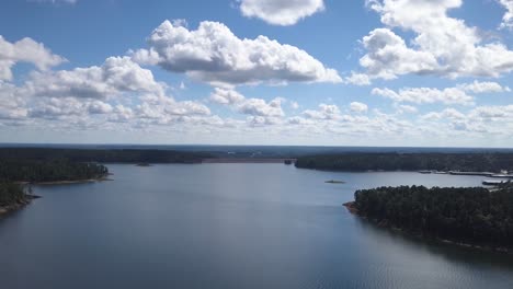 rising over blue lake drone shot