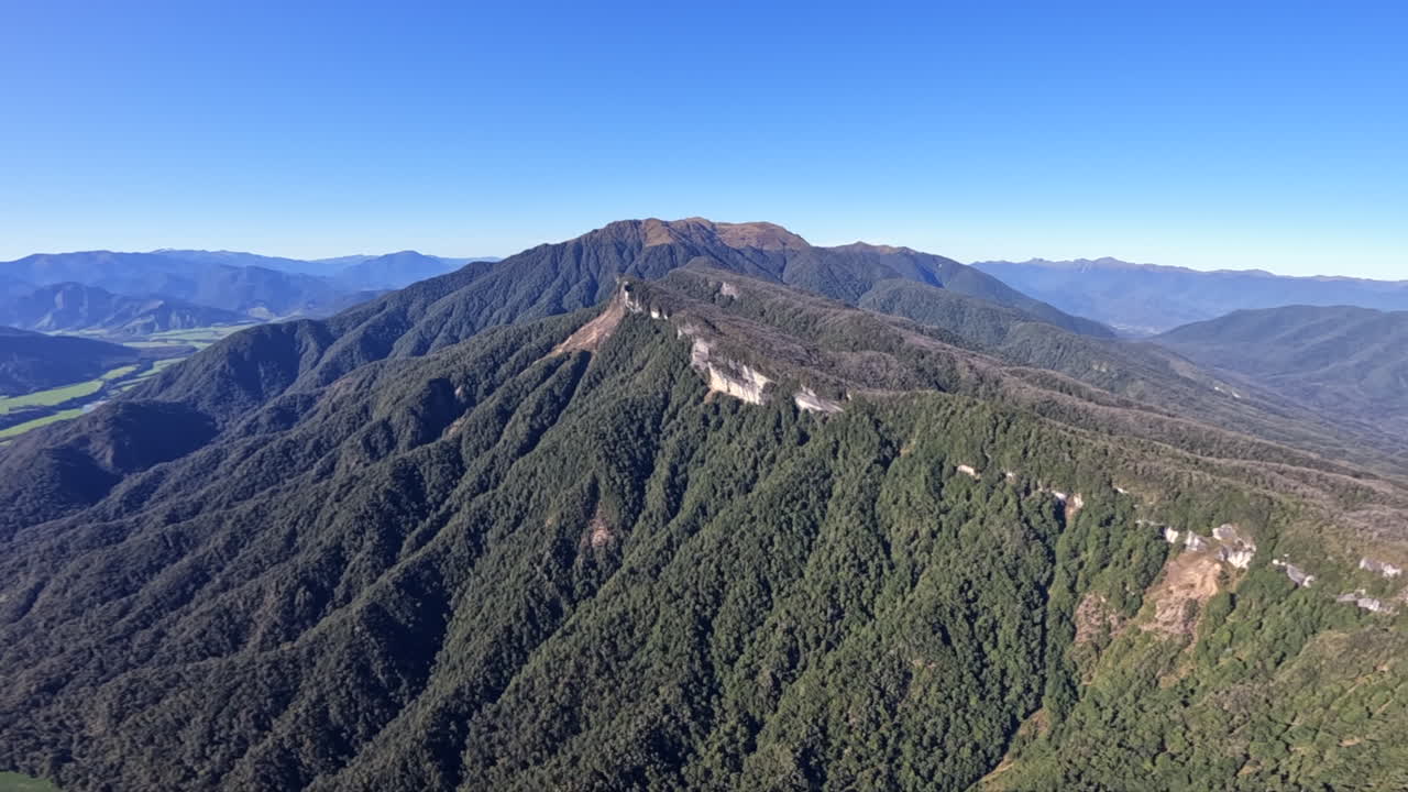 Aerial POV Shot from a Helicopter Flying over the start of the Southern Alps, New Zealand