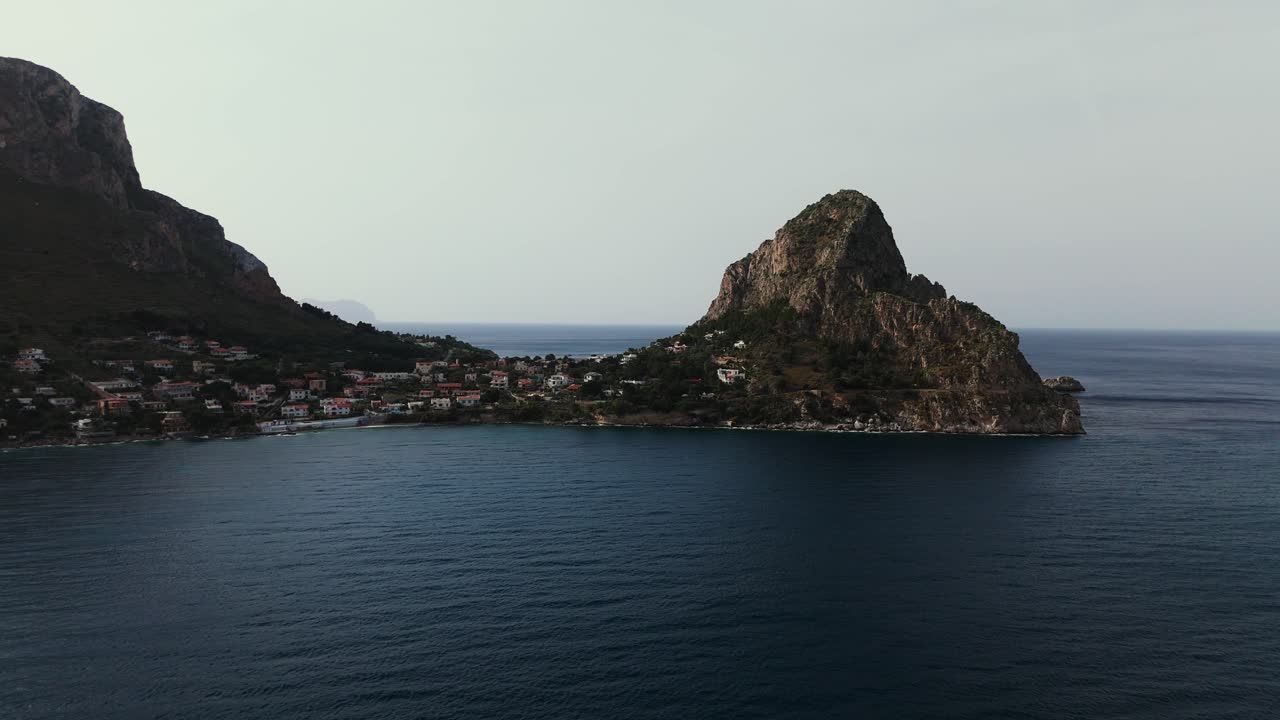 Cinematic slow motion 4K drone footage of Capo Zafferano and Sant Elia village along Sicily coast Italy showing rocky headland turquoise sea and dramatic coastal terrain near Bagheria and Porticello