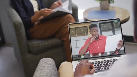 African-american-businessman-using-laptop-for-video-call-with-african-american-business-colleague