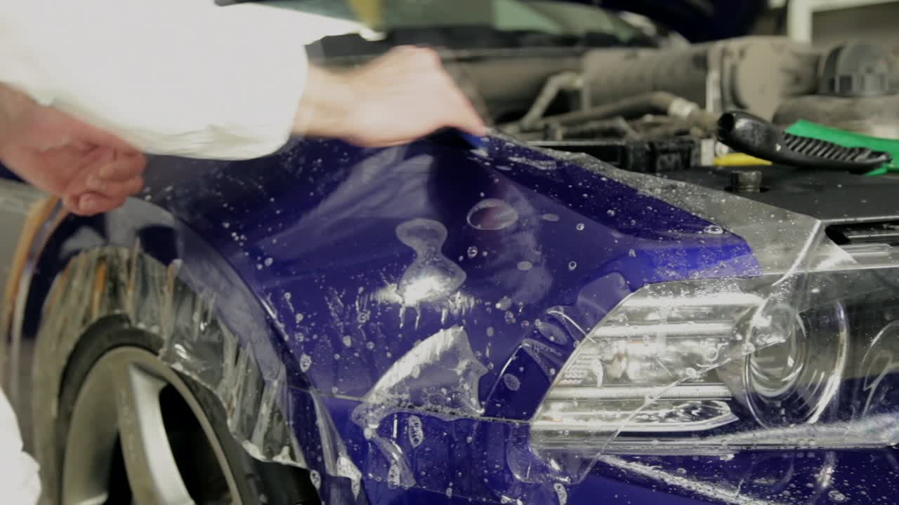 Applying Paint Protection Film to a Blue Car