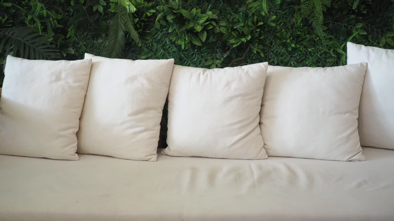 Couch with pillows and green wall