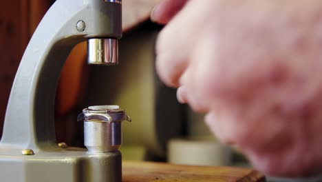 Horologist-repairing-a-watch-on-a-machine