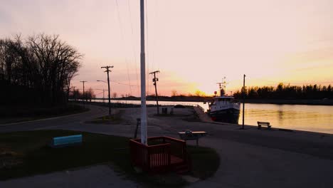 reverse track and rise to reveal the channel and sun set