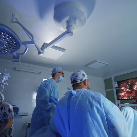 surgeons at work operating in surgical theatre