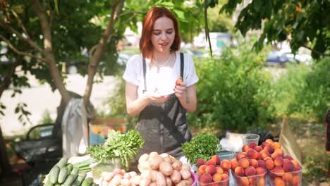 woman selling fresh produce at an outdoor market
