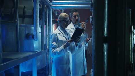 scientists inspecting industrial machinery