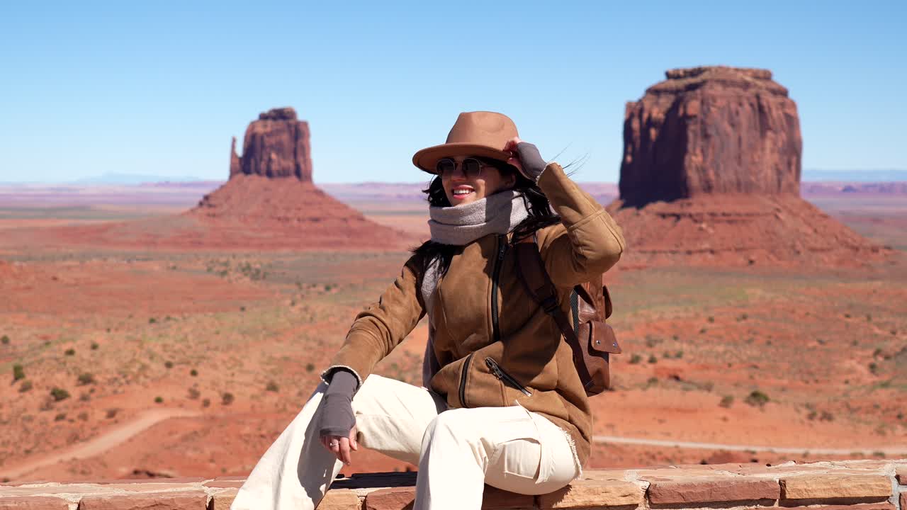 Happy Woman Sitting and Smiling in Scenic Monument Valley