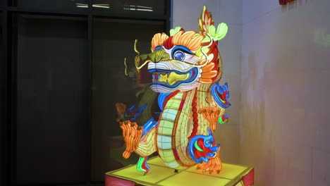 a dragon lantern installation illuminated outside the china cultural centre commemorating the upcoming chinese lunar new year 2024, the year of the dragon in spain