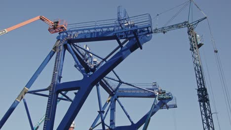 low angle pan of a pre-piling template being constructed at a dock in a harbor. the piling template will be used to place offshore wind turbines in deep water