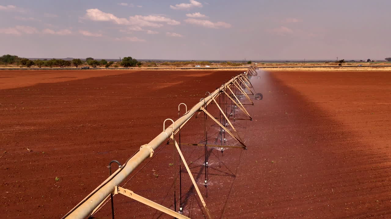 Drone flyover - irrigation system watering recently planted lands on a drought-hit farm, a reality of agriculture's fight for future food security and sustainability in the world