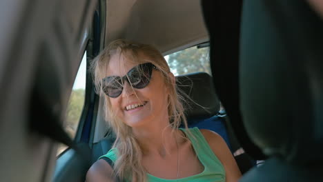 Young-woman-traveling-by-car-and-looking-out-window