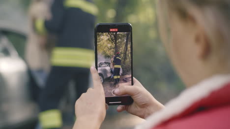 firefighter recording a car accident