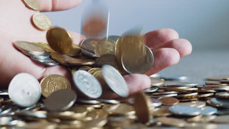 man hands holding a lot of coins. business concept