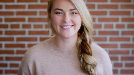 face, woman and university student by brick wall
