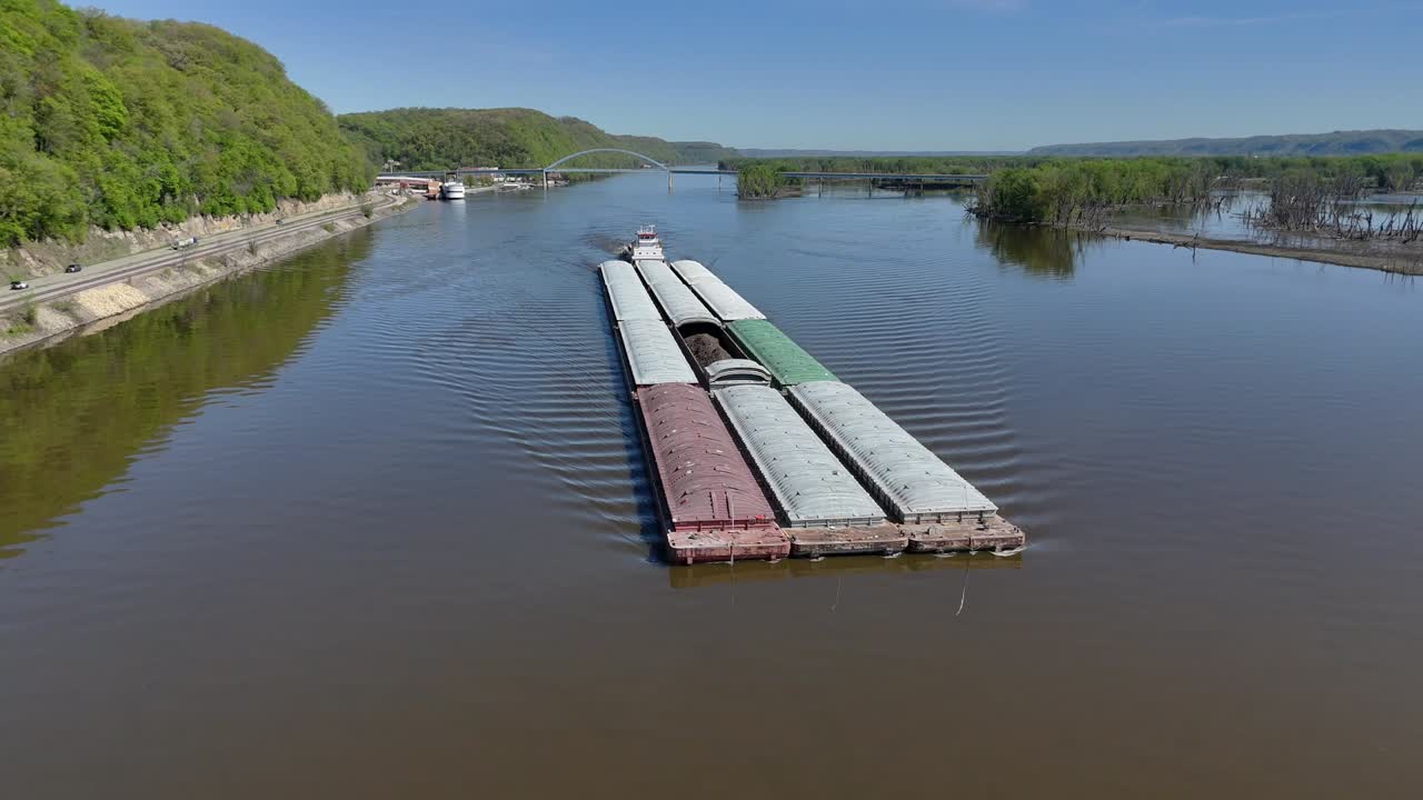 Located along the Mississippi River between Minnesota and Wisconsin's Driftless area, a towboat move a set of barges south.