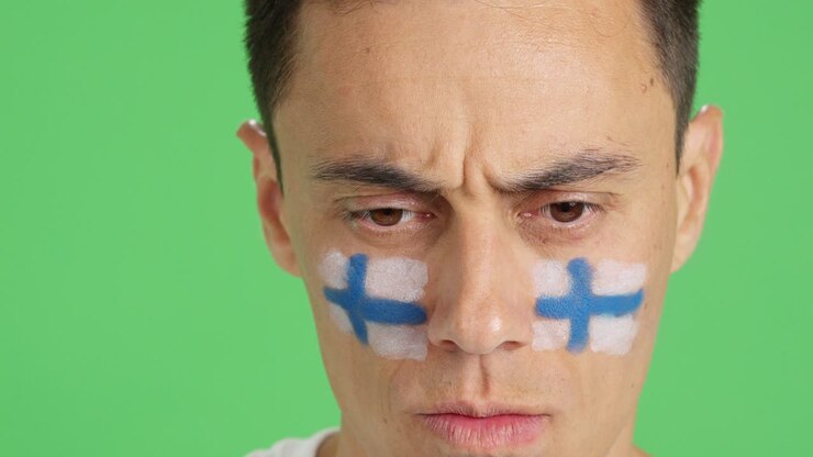 Serious man with a finnish flag painted on the face