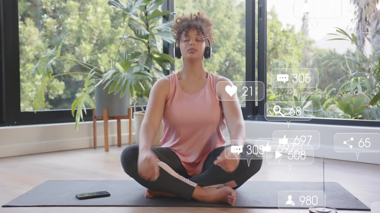 Woman on mat reaching for phone, notifications appearing, adjusting headphones, starting meditation
