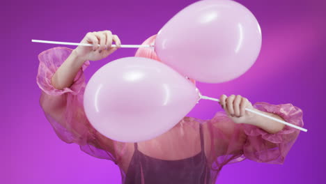 portrait shot of attractive woman wearing a pink wig and glasses