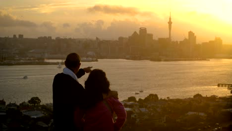 senior couple watching sunset in auckland city