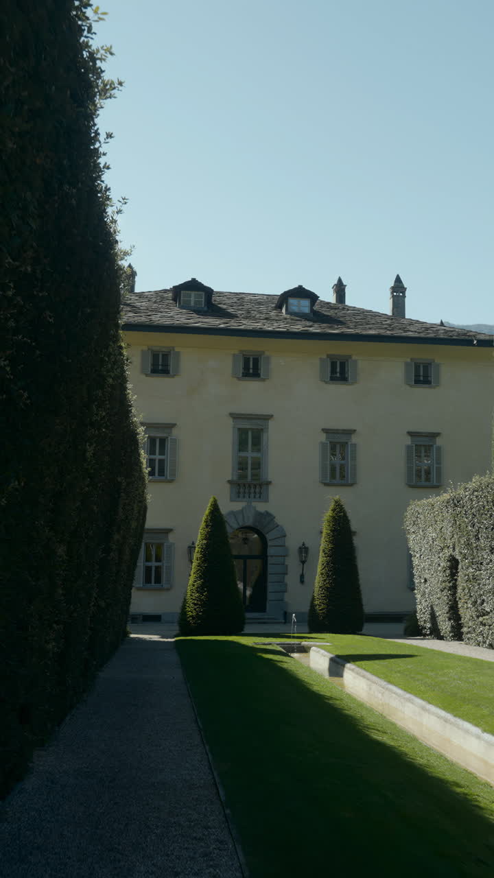 Exterior view of a stately building and formal garden