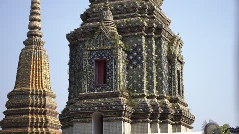 slow motion establishing shot of the beautiful pagodas at the wat pho temple