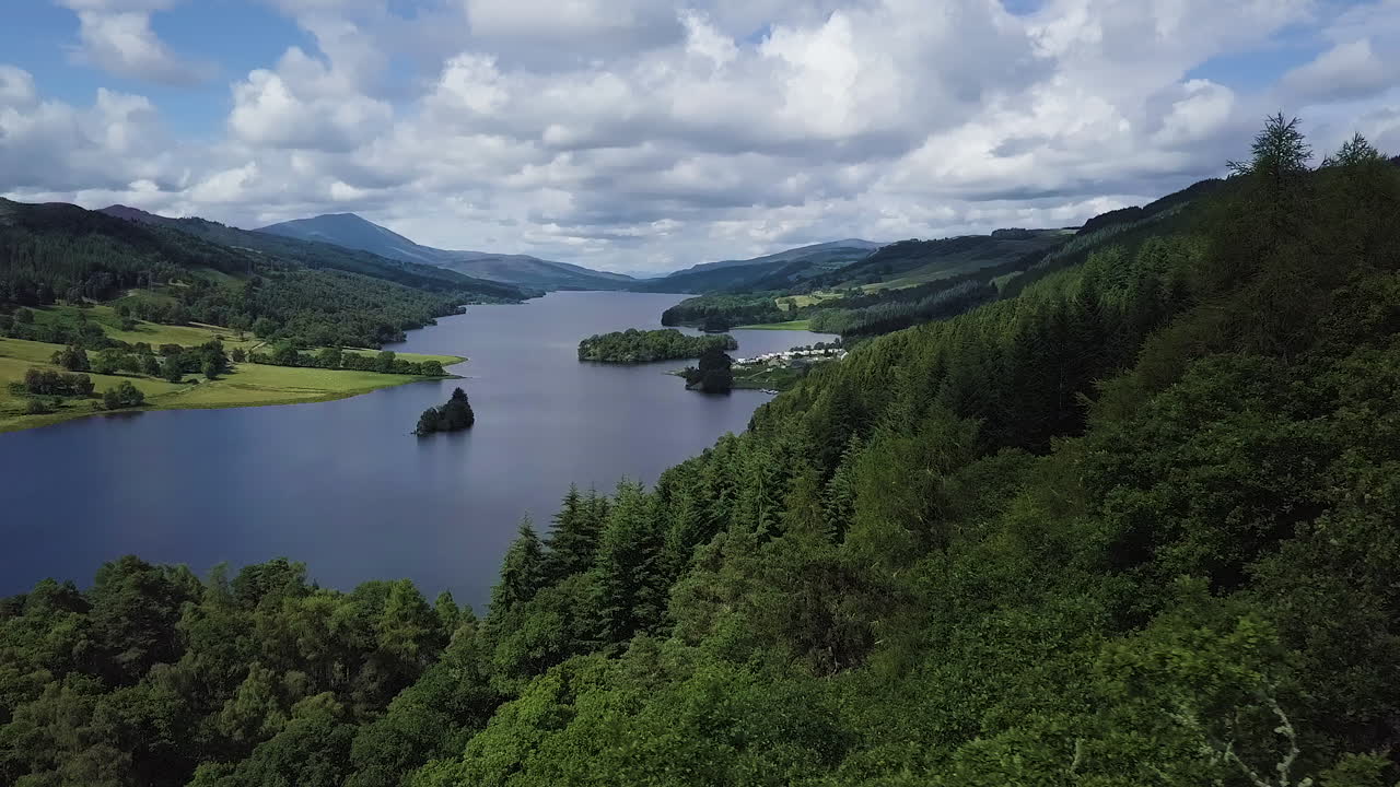 Aerial view over forrest and Loch Tummel in the scotish highlands on a cloudy summer day.