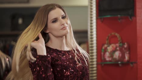 woman trying on a sequined dress in a boutique