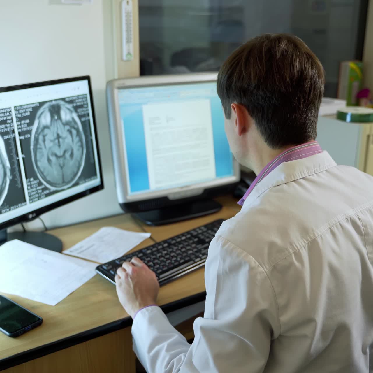 Physician Using Computer In Hospital Office. Professional medical doctor working in hospital office using computer technology