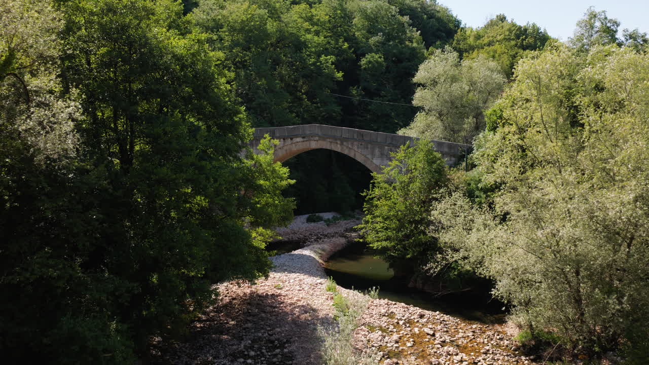 Stone Arch Bridge Spanning Miljacka River In Bosnia and Herzegovina. - aerial shot