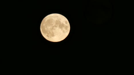 Primer-Plano-De-La-Superficie-Del-Cráter-De-La-Luna-Llena-De-Cosecha-Brillante-Que-Pasa-A-Través-Del-Cielo-Oscuro