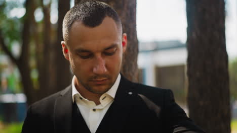 gentleman in black costume with shirt in spring city park