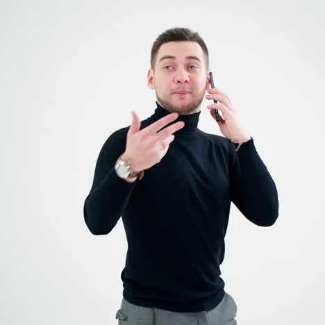 Smiling man walks and talk the phone on white background. Handsome businessman giving instructions through the mobile phone conversation.