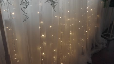 softly lit sheer curtains with delicate string lights, creating a warm and cozy ambiance