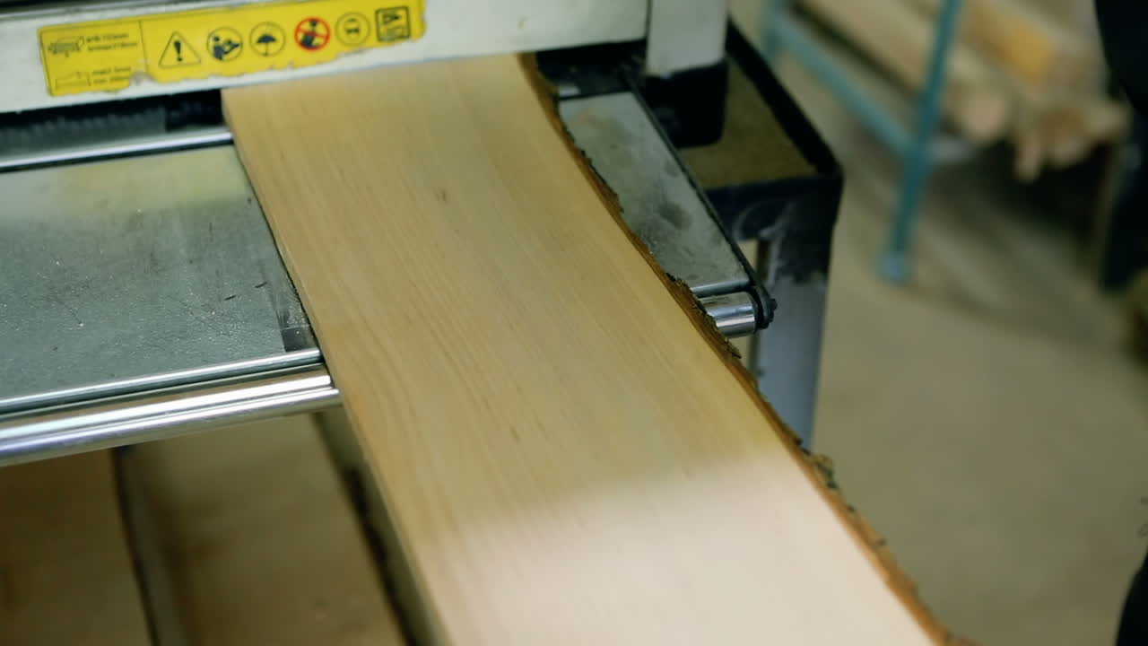 Sawing A Wooden Plank With Jig Saw. Man uses an electric saw to cut wooden planks